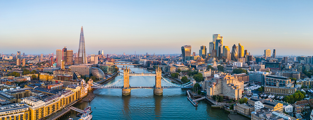 Panoramic Aerial View Of Tower Bridge And The London City Skyline At Sunrise, UK