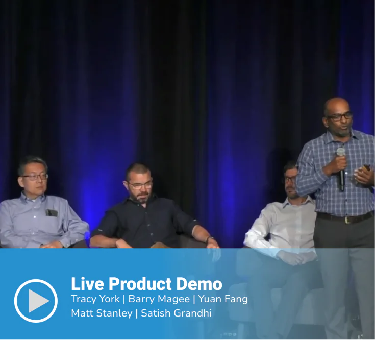 Video thumbnail of a "Live Product Demo" featuring speakers Tracy York, Barry Magee, Yuan Fang, Matt Stanley, and Satish Grandhi on stage, with three panelists seated and one speaker standing holding a microphone against a dark blue-lit backdrop.